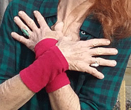 thermal layer red wrist warmers on women's wrist