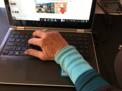 thermal layer wrist warmers hand with blue wrist warmer using computer